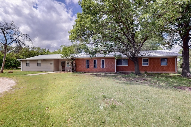 view of front of house with brick siding and a front lawn