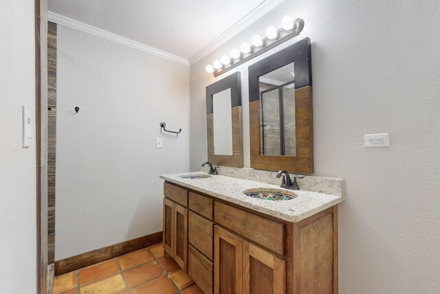 full bath with baseboards, crown molding, a sink, and double vanity