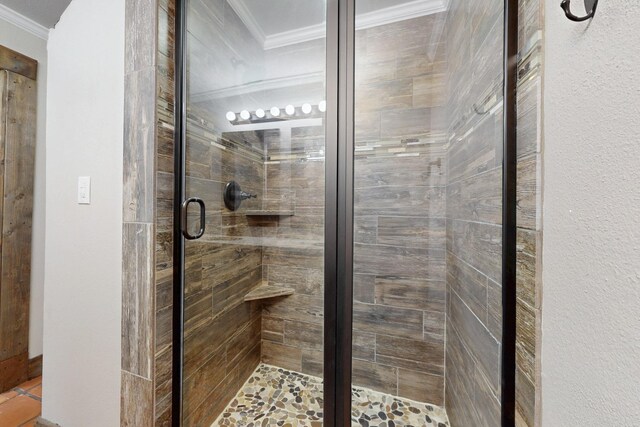 full bathroom featuring a shower stall and crown molding