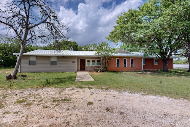 view of front of property with a front lawn and metal roof