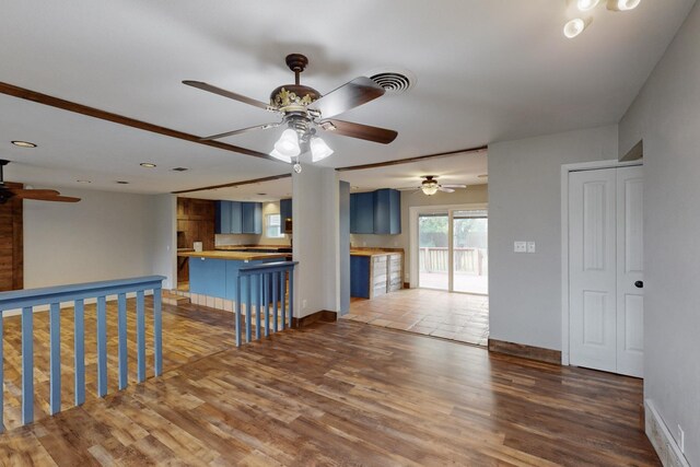empty room with recessed lighting, wood finished floors, a ceiling fan, and baseboards