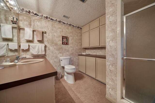 bathroom featuring visible vents, vanity, a shower stall, and toilet