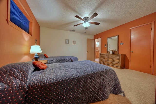 bedroom with visible vents, carpet floors, a textured ceiling, and ceiling fan