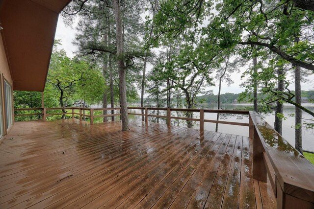 wooden terrace featuring a water view
