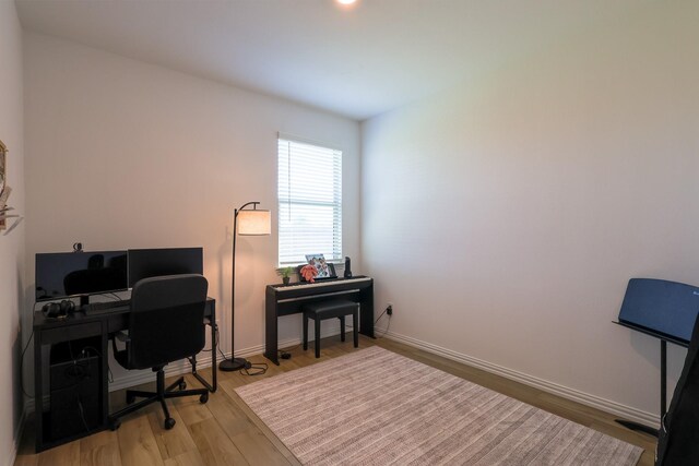 office area with light wood-style flooring and baseboards