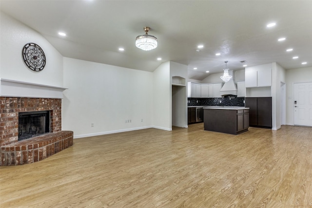 608 Piper Dr, Saginaw, TX 76179 - kitchen with decorative backsplash, open floor plan, white cabinets, lofted ceiling, and a kitchen island