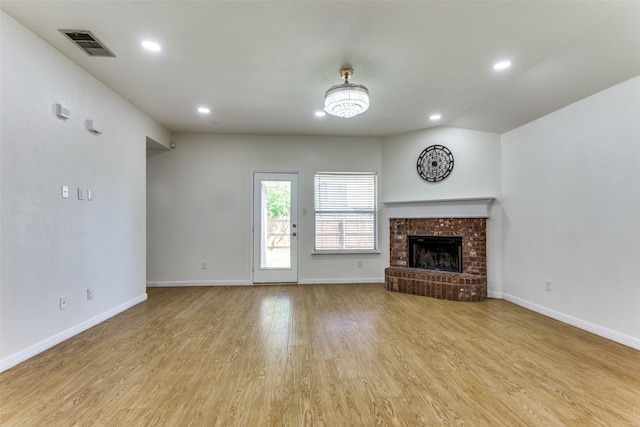 608 Piper Dr, Saginaw, TX 76179 - unfurnished living room with recessed lighting, wood finished floors, visible vents, baseboards, and a fireplace
