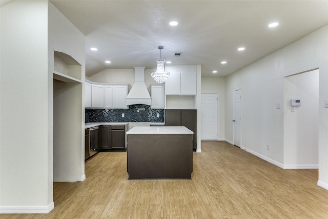 608 Piper Dr, Saginaw, TX 76179 - kitchen featuring light wood-style flooring, a center island, custom exhaust hood, and a notable chandelier