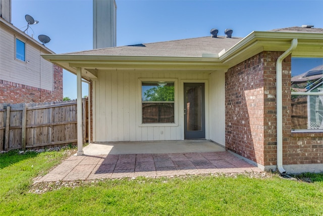 608 Piper Dr, Saginaw, TX 76179 - doorway to property featuring brick siding, roof with shingles, fence, and a patio area
