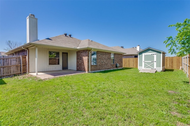 608 Piper Dr, Saginaw, TX 76179 - rear view of house with a chimney, a fenced backyard, a patio area, a lawn, and a storage unit