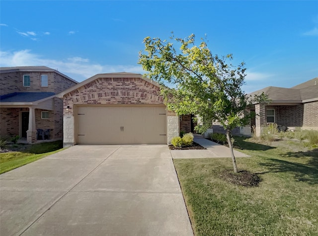 view of front facade featuring an attached garage, driveway, brick siding, and a front yard