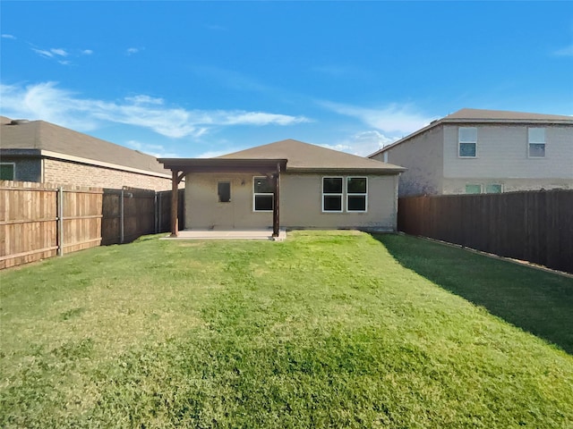 back of property with a patio, a fenced backyard, and a yard