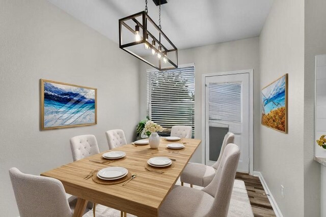 dining room featuring baseboards and wood finished floors