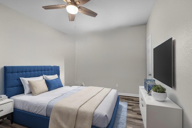 bedroom with baseboards, a ceiling fan, and wood finished floors