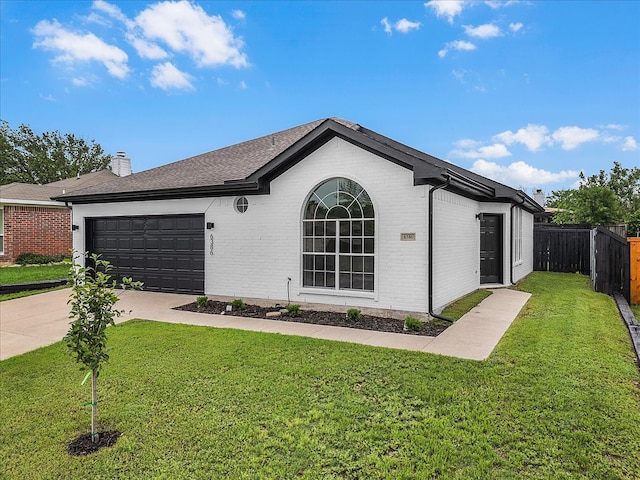 ranch-style home with a front yard, brick siding, fence, concrete driveway, and an attached garage
