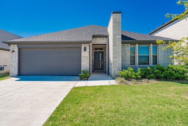 single story home with a chimney, a front lawn, driveway, an attached garage, and brick siding