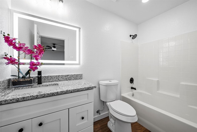 1124 Faulkner Ln, Waco, TX 76704 - bathroom featuring toilet, vanity, tub / shower combination, wood finished floors, and a ceiling fan