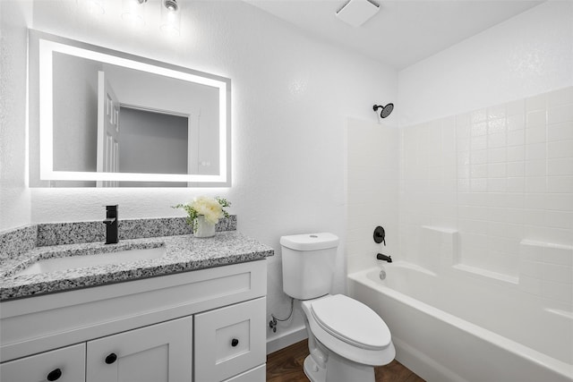 1124 Faulkner Ln, Waco, TX 76704 - bathroom with vanity, toilet, shower / bath combination, wood finished floors, and baseboards