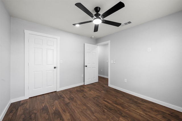 1124 Faulkner Ln, Waco, TX 76704 - unfurnished bedroom featuring baseboards, dark wood-type flooring, and ceiling fan
