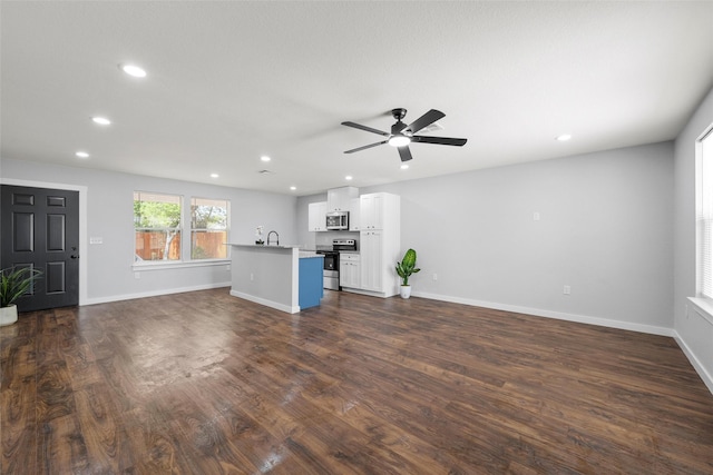 1124 Faulkner Ln, Waco, TX 76704 - unfurnished living room featuring dark wood-style flooring, recessed lighting, ceiling fan, and baseboards