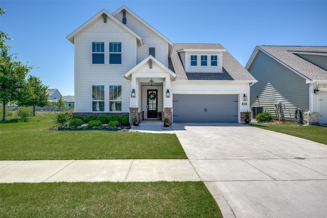 view of front of house featuring a front lawn, central AC, concrete driveway, an attached garage, and roof with shingles