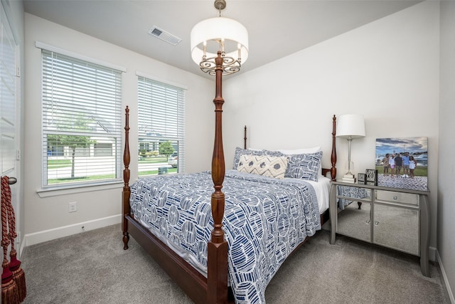 bedroom featuring baseboards, visible vents, carpet, and a notable chandelier