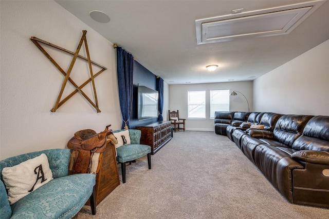 living area featuring attic access and carpet floors
