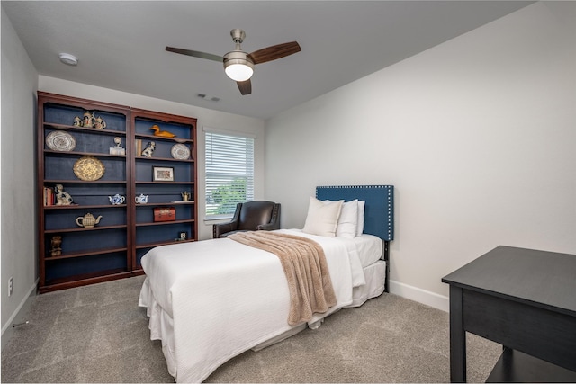 carpeted bedroom featuring visible vents, baseboards, and ceiling fan