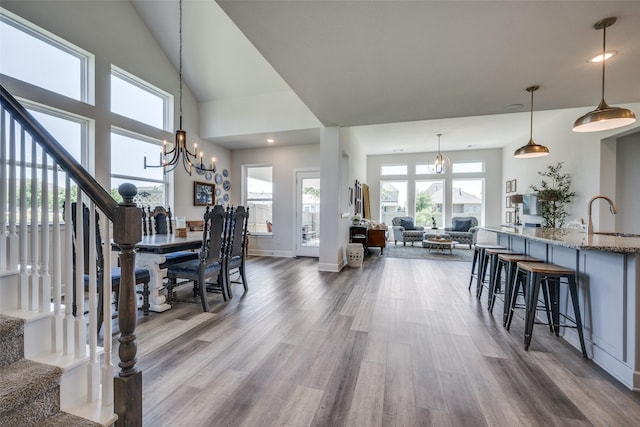 living area featuring recessed lighting, stairway, dark wood-type flooring, baseboards, and a chandelier