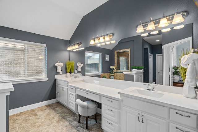 1884 Knoxbridge Rd, Forney, TX 75126 - bathroom featuring lofted ceiling, a sink, double vanity, and baseboards