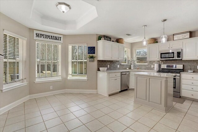 kitchen with a wealth of natural light, appliances with stainless steel finishes, and tasteful backsplash