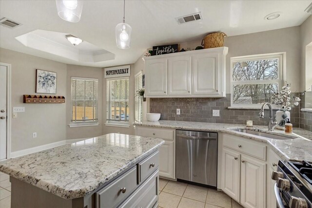 kitchen with a sink, visible vents, appliances with stainless steel finishes, light stone countertops, and light tile patterned floors