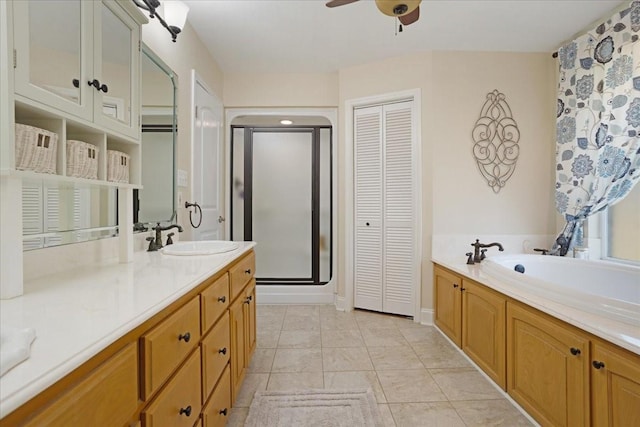 full bathroom featuring a shower stall, vanity, a closet, a garden tub, and ceiling fan