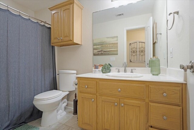 bathroom with tile patterned floors, visible vents, vanity, and toilet