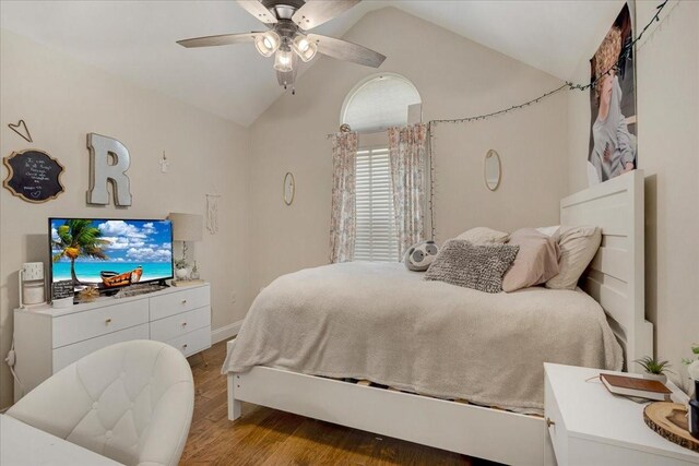 bedroom featuring baseboards, vaulted ceiling, wood finished floors, and ceiling fan