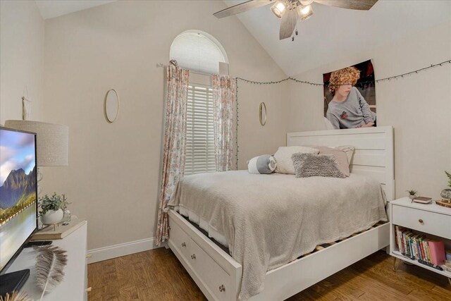 bedroom with vaulted ceiling, a ceiling fan, baseboards, and wood finished floors