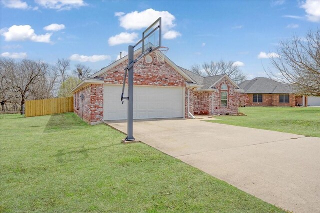exterior space with an attached garage, brick siding, fence, and driveway