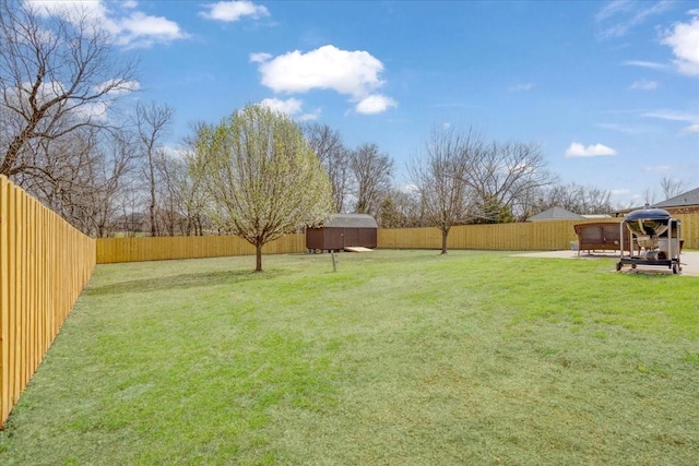 view of yard featuring a fenced backyard, an outbuilding, a gazebo, and a shed