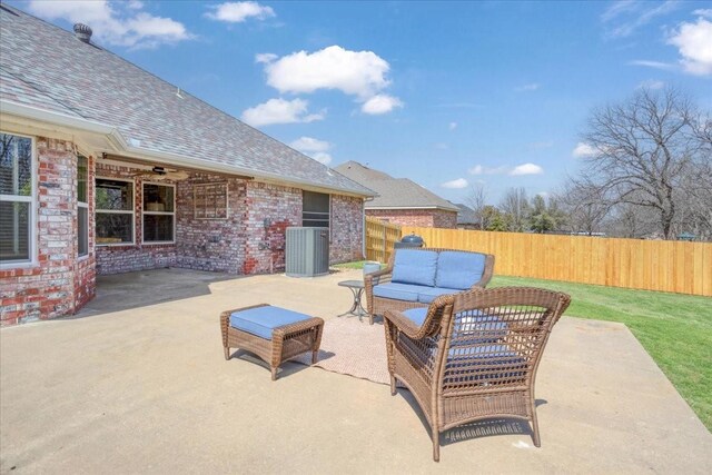 view of patio with an outdoor living space, a fenced backyard, and central air condition unit