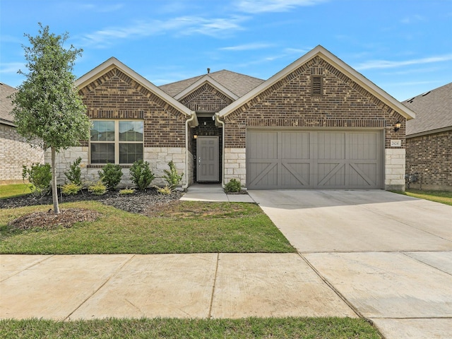 single story home featuring concrete driveway, stone siding, an attached garage, a front yard, and brick siding