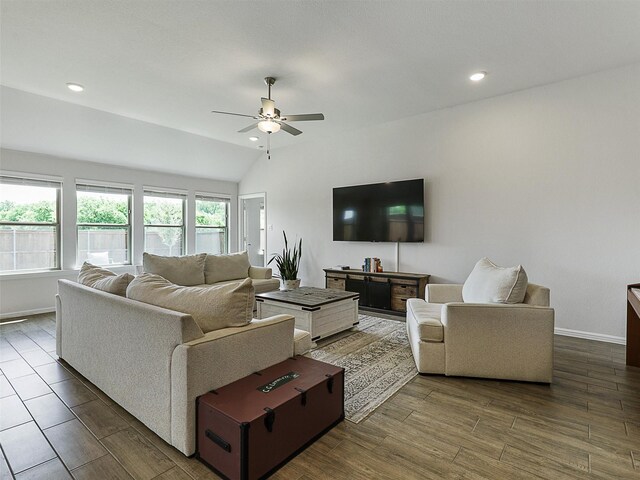 living area with lofted ceiling, baseboards, a ceiling fan, and wood finished floors