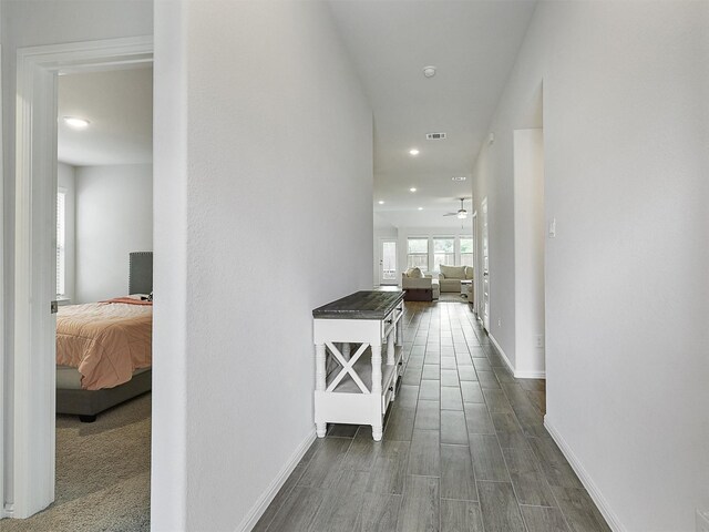 hall featuring recessed lighting, visible vents, baseboards, and dark wood-style floors