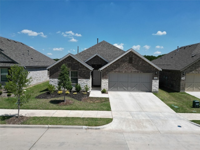ranch-style home with concrete driveway, a front lawn, stone siding, a garage, and roof with shingles