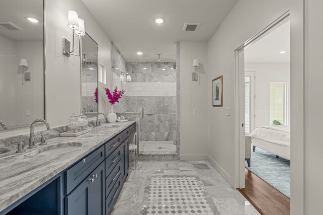 full bath with a shower stall, double vanity, visible vents, and a sink