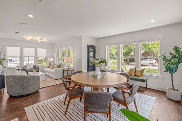 dining room with wood finished floors, visible vents, and recessed lighting