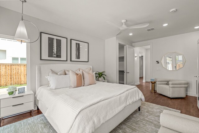 bedroom with a ceiling fan, wood finished floors, baseboards, visible vents, and recessed lighting