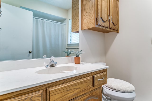 bathroom featuring vanity and toilet