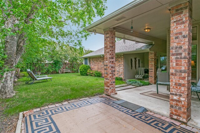 view of patio featuring fence