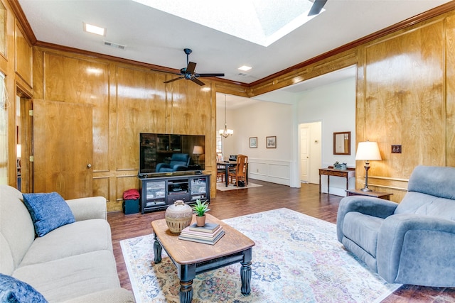 living area featuring ceiling fan with notable chandelier, dark wood-style flooring, visible vents, and crown molding