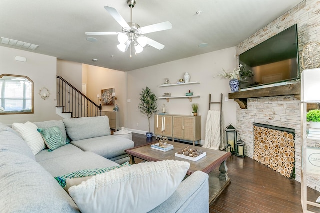 living room with a ceiling fan, stairs, hardwood / wood-style flooring, a fireplace, and visible vents